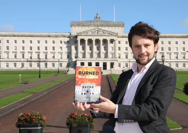 News Letter political editor Sam McBride pictured in front of Stormont with his book Burned