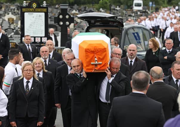 June 30: Bobby Storey's coffin is draped in the Irish tricolour as it is carried through Milltown Cemetery. The coffin was then taken to Roselawn Crematorium for a private service. (Photo: PA Wire)