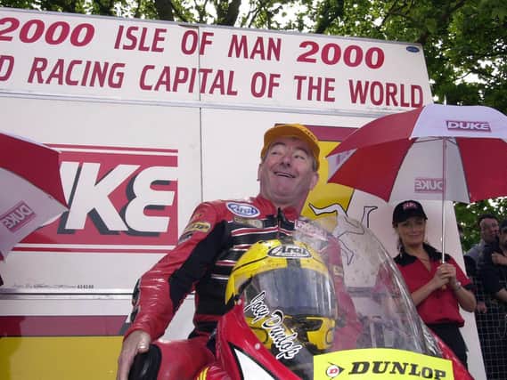 Joey Dunlop has a wry smile after winning the Formula One race at the Isle of Man TT in 2000 after someone asks if he is 'too old' to get his leg over his bike.