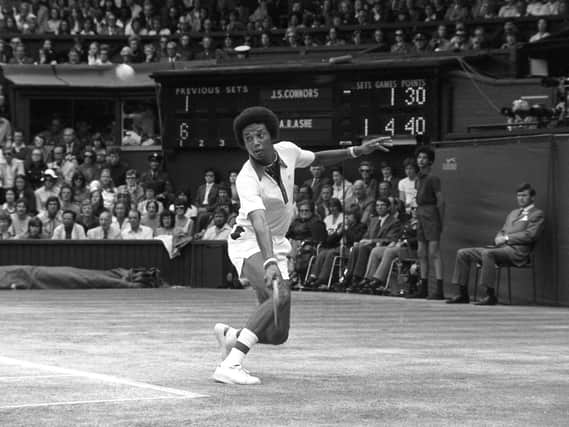 American Arthur Ashe in action against reigning champion Jimmy Connors during the Wimbledon Men's Single Competition