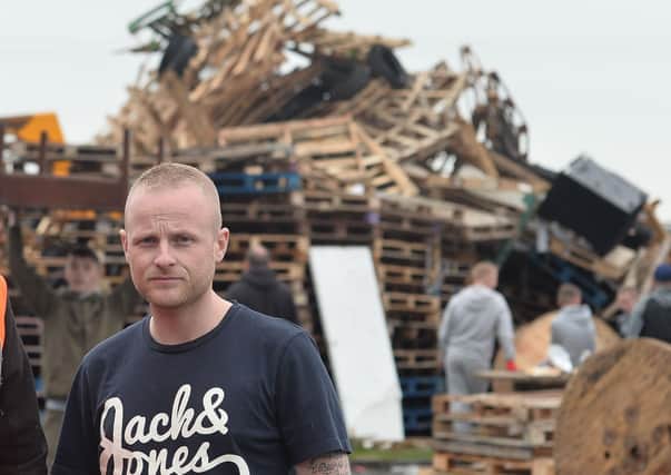 Jamie Bryson last year as bonfire builders at the Avoniel Leisure Centre removed tyres from their bonfire. Jamie Bryson says this year: "Towering bonfires would be manna from heaven for the republican movement, and a real and present public health risk". Photo Pacemaker Press