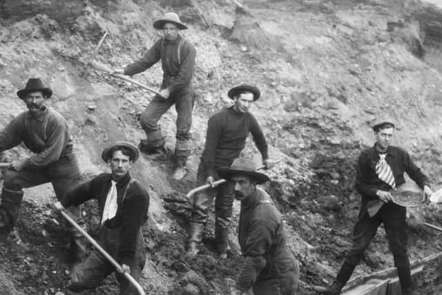 `The men who moil for gold.'  Miners Working a Chute on Bonanza Creek.