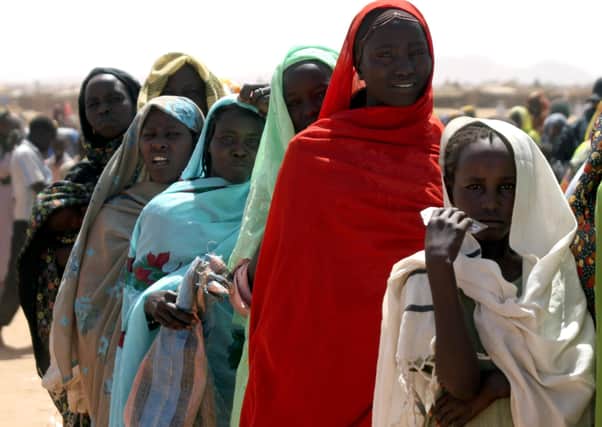 Refugees line up for a distribution of blankets, mats and plastic jerricans in 2007 in a refugee camp, North Darfur, Sudan. Photo: Alfred de Montesquiou/AP