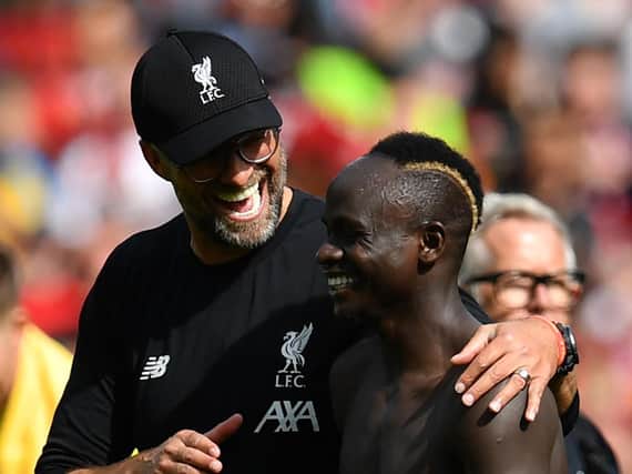 Jurgen Klopp (R) gestures with Liverpool's Senegalese striker Sadio Mane