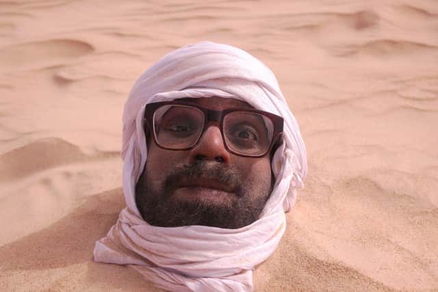 Romesh having a sand bath in the Sahara