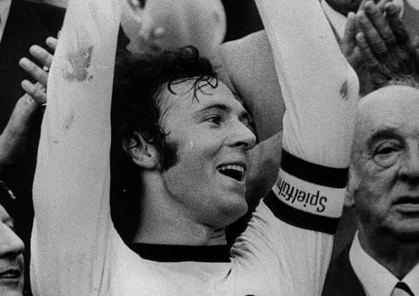File photo dated 09-07-1974 of Captain Franz Beckenbauer holds the World Cup trophy after beating Holland 2-1 in the final at Munich, Germany.