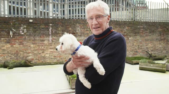 Paul O'Grady at Battersea with an adorable four-month-old Bichon Frise pup called Bobby