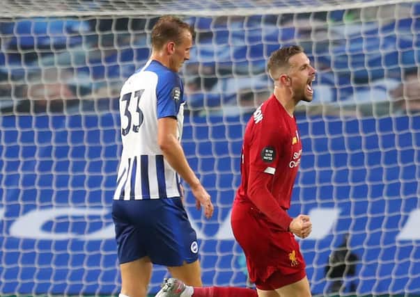 Liverpool's Jordan Henderson (centre) celebrates scoring his side's second goal of the game during the Premier League match at the AMEX Stadium, Brighton. Pic by PA.