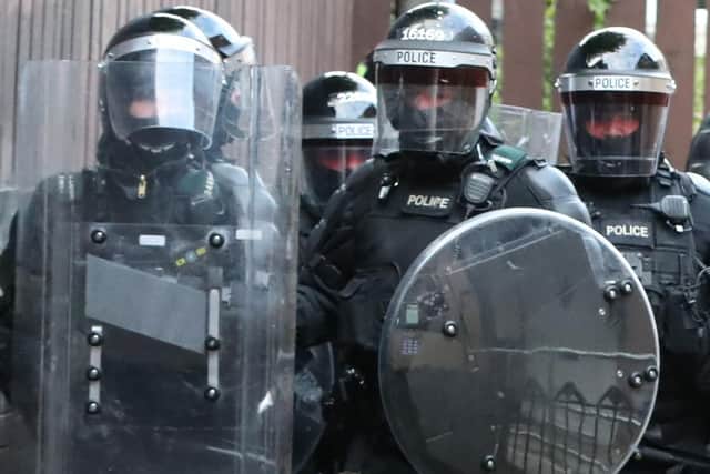 PSNI officers in riot gear carry out searches in the New Lodge area of Belfast, as police have warned of consequences for those involved in a day of disorder in north Belfast.