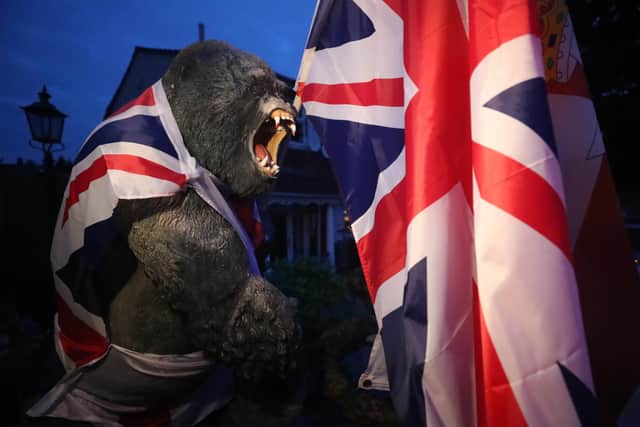 A plastic gorilla is wrapped in Union flag by a bonfire on Belfast's Shankill Road ahead of midnight on Saturday. Photo: Niall Carson/PA Wire