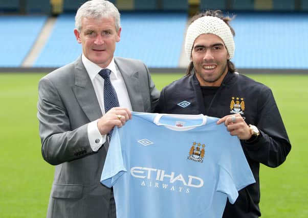 File photo dated 14-07-2009 of Manchester City new signing Carlos Tevez with manager Mark Hughes following a press conference at the City of Manchester Stadium, Manchester.