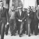 Shipyard workers arriving at the Grosvenor Hall in Belfast in May 1965 to attend a mass meeting to discuss the labour dispute which had lead to a two week strike. More than 3,500 men were made idle because of the dispute between the Boilermakers Society and management. By the end of the meeting it had been agreed that it was back to work, a decision which the News Letter noted was welcomed by both sides of the strike. (NEWS LETTER ARCHIVES)