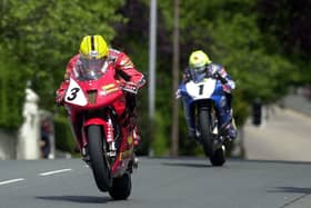 Joey Dunlop (Honda VTR SP-1) leads Ian Lougher in the Formula One race at the Isle of Man TT in 2000.