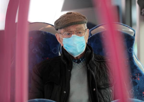 A man riding a Metro bus in Belfast, after face masks were made compulsory on public transport
