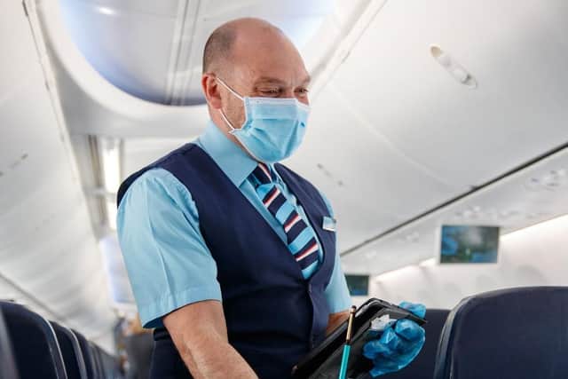 TUI flight attendants in PPE and passengers wearing masks. Photo: Ben Queenborough/PinPep/TUI/PA Wire