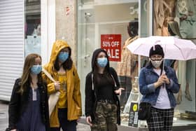 A group of young women walk through Belfast city centre's shopping district wearing face masks voluntarily on Tuesday, the day it was announced face masks will become mandatory in shops in England. Robin Swann has advised the same for Northern Ireland. Photo: Liam McBurney/PA Wire