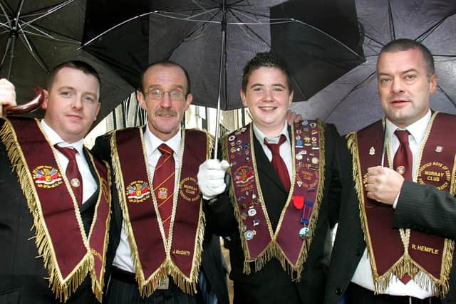 Pictured in 2006 sheltering from the weather during Lundy Day events in Londonderry are Mark Beattie, John McGinty, Scott Baillie and Richard Hemple. Picture: Margaret McLaughlin/Londonderry Sentinel archives
