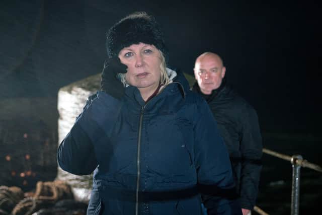 Phelan, as played by Connor McIntyre, is comforting Eileen Phelan, as played by Sue Cleaver, who has cut her foot but when she gets a few bars of signal on her phone the message from Tim comes through - horrified she tries to persuade oblivious Phelan to go back to the boat but as she heads towards the harbour to try and call Tim back she is unaware he has followed her