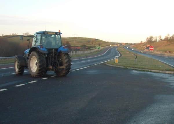 Tractors are allowed on dual carriageways such as this one, the A1 in Co Down, where a tractor can be seen crossing through a gap junction between Loughbrickland and Beech Hill