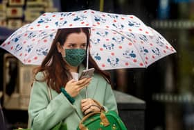 A woman wears a mask as she walks through Belfast city centre earlier this week. (Photo: PA Wire)