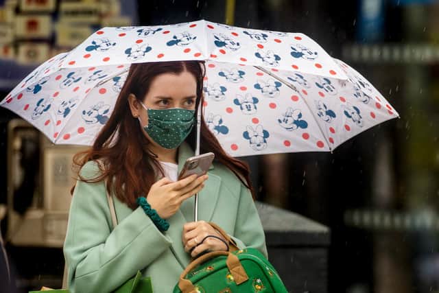 A woman wears a mask as she walks through Belfast city centre earlier this week. (Photo: PA Wire)