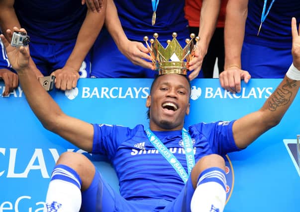 File photo dated 24-05-2015 of Chelsea's Didier Drogba celebrating with the lid of the Premier League trophy after the Barclays Premier League match at Stamford Bridge, London.