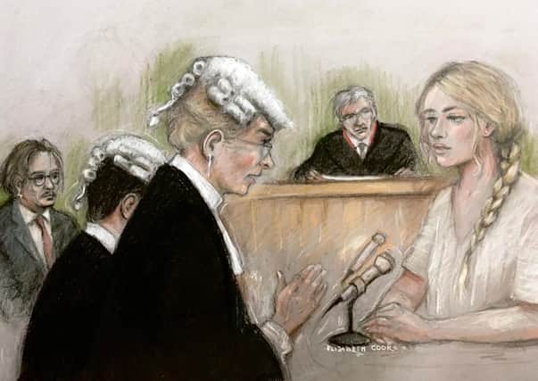 Court artist sketch by Elizabeth Cook of actress Amber Heard being questioned by Sasha Wass QC as she gives evidence at the High Court in London during a hearing in Johnny Depp's libel case