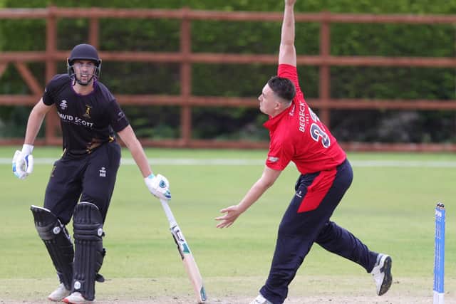 Lee Nelson bowling for Waringstown as Nikolai Smith of Instonians looks on