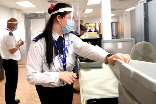 Security staff at Belfast International Airport wear face sheilds as part of the Coronavirus restrictions