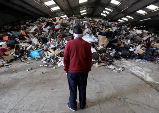 A resident pictured by some of the waste on Monday