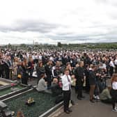 Crowd in Milltown Cemetery listening to former Sinn Fein President Gerry Adams speak during the funeral of Bobby Storey.
