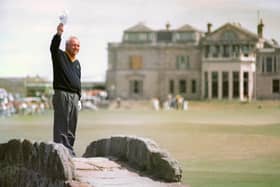 Arnold Palmer waves farewell to St Andrews on the Swilken Bridge, overlooking the 18th, on day two of the Open Golf Championship in 1995.