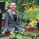 Esther Tolburn with her dog Daisy in the garden of her home in the Ravenhill area of Belfast. Esther is developing a permaculture of trees and plants which is intended to be sustainable and self-sufficient. 
PICTURE BY STEPHEN DAVISON