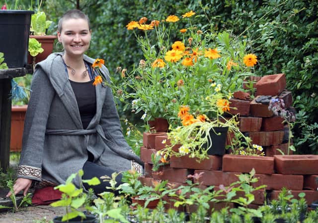 Esther Tolburn with her dog Daisy in the garden of her home in the Ravenhill area of Belfast. Esther is developing a permaculture of trees and plants which is intended to be sustainable and self-sufficient. PICTURE BY STEPHEN DAVISON