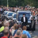 People line the streets as the funeral cortege of Jack Charlton passes through his hometown of Ashington, in Northumberland ahead of his funeral service at West Road Crematorium, in Newcastle.