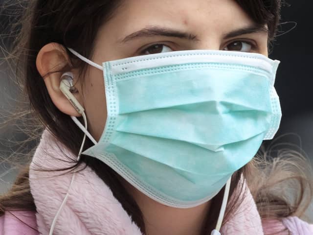 A woman wearing a face mask in Leeds, West Yorkshire