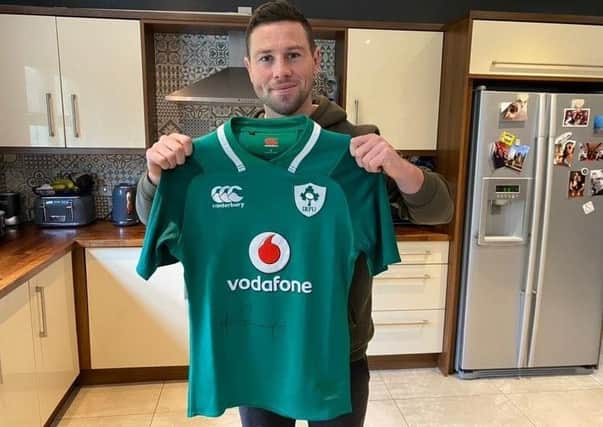 John Cooney with the signed rugby jersey