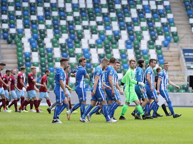 Coleraine and Ballymena United players take to the pitch