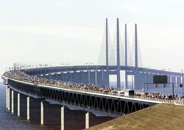 Thousands of people celebrate the opening of the Öresund bridge linking Denmark to Sweden 20 years ago. At five miles long, it is a fraction of the proposed 20-mile NI-Scotland bridge but there are such bridges, including Hong Kong-Zhuhai-Macau