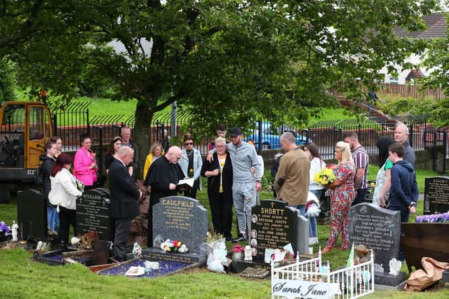 The family of Joleen Corr gather for a graveside service