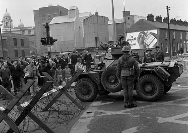 A military armoured car and barbed wire road block in Divis Street, Belfast. Photo: PA