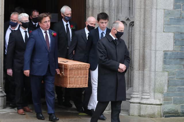 The casket of the former SDLP leader John Hume is carried from St Eugene's Cathedral following his funeral Mass.
