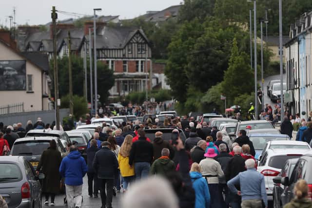 People follow the funeral cortege of the former SDLP leader John Hume as it leaves St Eugene's Cathedral in Londonderry following his funeral Mass.