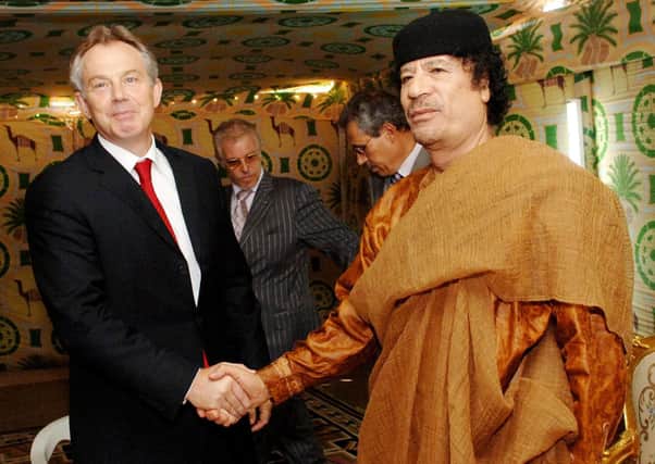 Former Prime Minister Tony Blair meeting Libyan leader Colonel Muammar Gaddafi outside Tripoli in 2011. Photo: Stefan Rousseau/PA Wire
