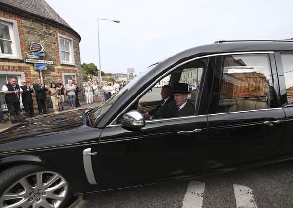 The remains of beloved former UTV Brian Black make their way through Strangford as crowds gather to bid a final farewell to the famed conservationist after he lost his life early last week in a tragic accident.