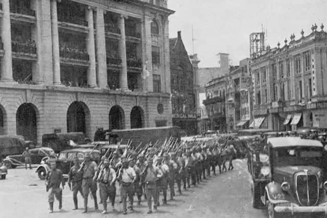 Battle of Singapore, February 1942. Victorious Japanese troops March Through the City Centre. (Photo from Imperial War Museum)