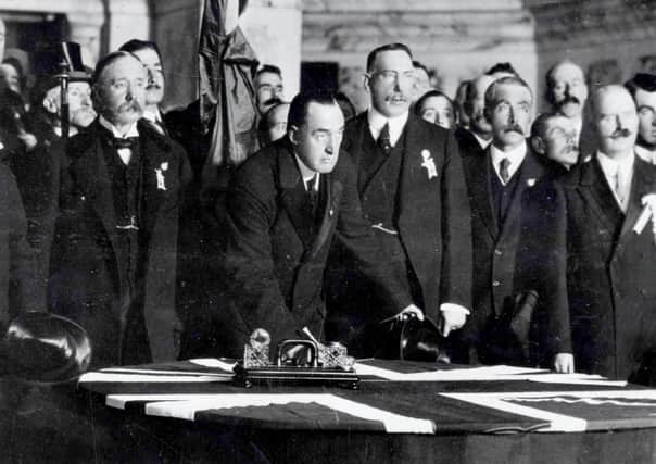 Sir Edward Carson signing the Ulster Covenant, Belfast City Hall, Sept 28th 1912. 

To Left Lord Charles Beresford (later Lord Bereford) and Lord Londonderry on the other side of Sir Edward is Captain Craig (Lord Craigavon) and M.J.H Cambell KC (Lord Glenavy) with Dr William Gibson. Imemdiately behind Lord Charles Beresford is Colonel R H Wallace and immediately behind Col. Wallace is Mr Ronald M Neill (Lord Cushendun)