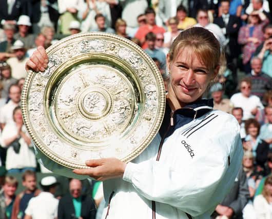 Steffi Graf with the Ladies' Singles trophy for the seventh time on Centre Court at Wimbledon in 1996.