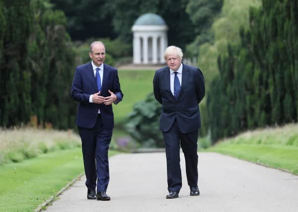 Prime Minister Boris Johnson (right) and Taoiseach Micheal Martin walking in the gardens of Hillsborough Castle during the Prime Minister's visit to Belfast on Thursday. Mr Johnson talked about the government's intention to mark Northern Ireland's centenary. Photo: Brian Lawless/PA Wire