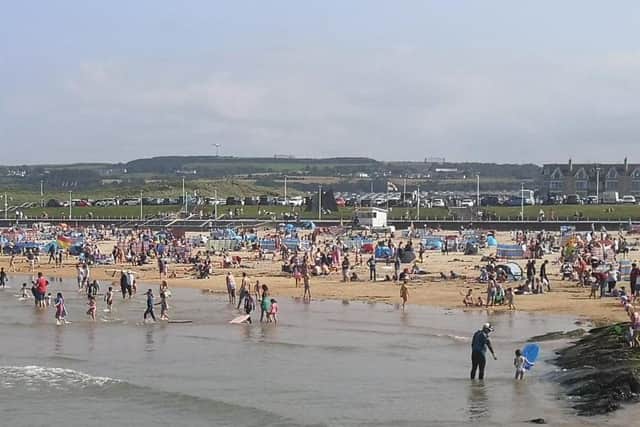 THOUSANDS of people flocked to the North Coast on saturday soaking up
sunshine on the sand as temperatures soared across Northern Ireland.Picture McAuley Multimedia